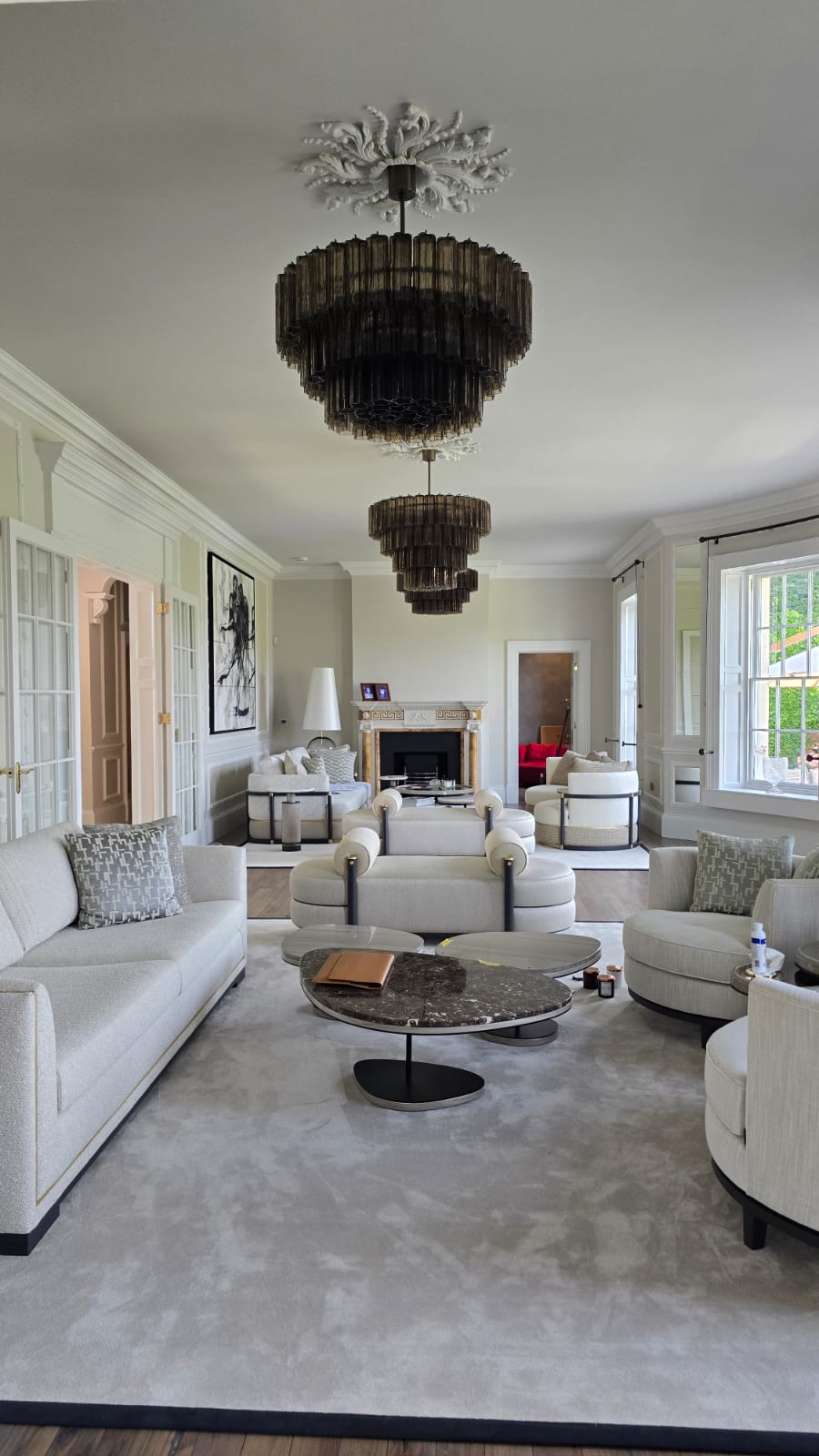 Period drawing room with paired Murano chandeliers and original cornicing in a Cotswolds country house