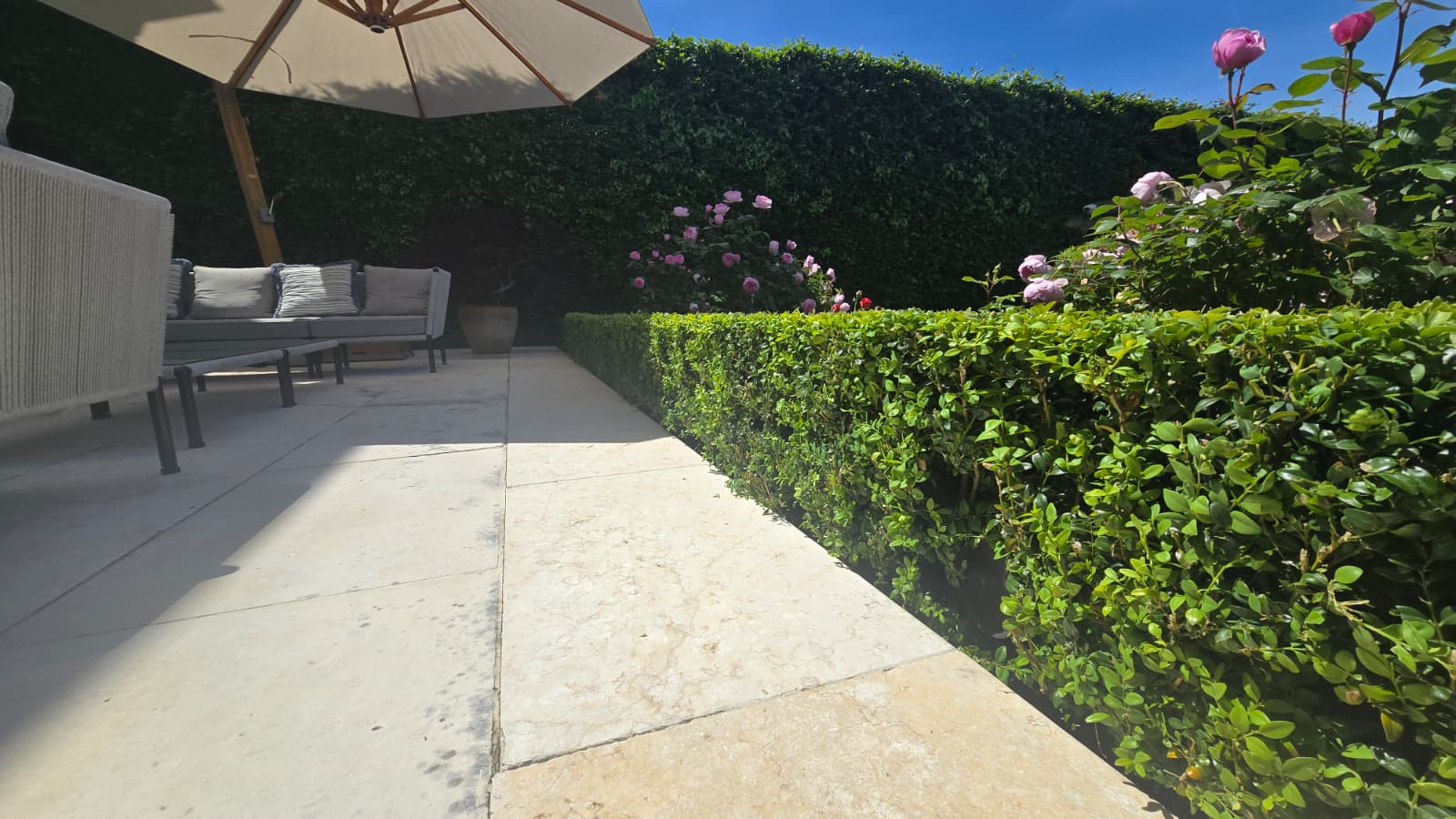 Formal parterre garden with hidden Sonance Garden Series speakers concealed among the box hedging