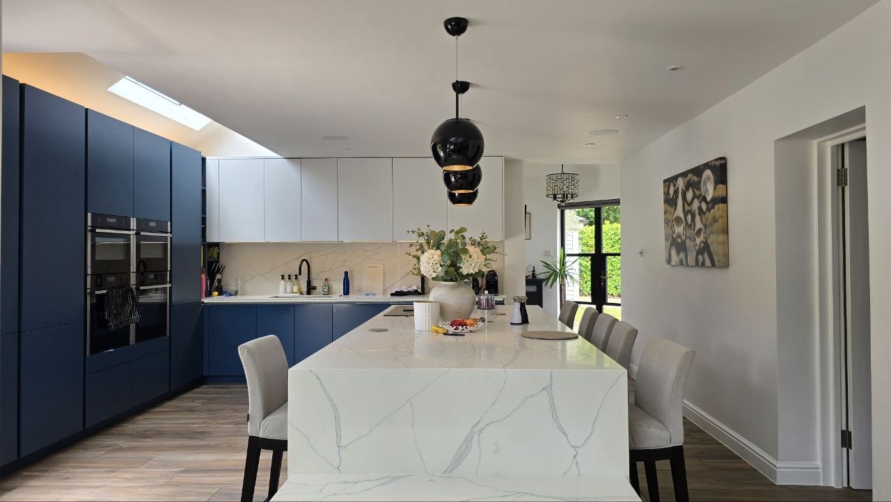 Open-plan kitchen with architectural in-ceiling speakers in an Englefield Green smart home