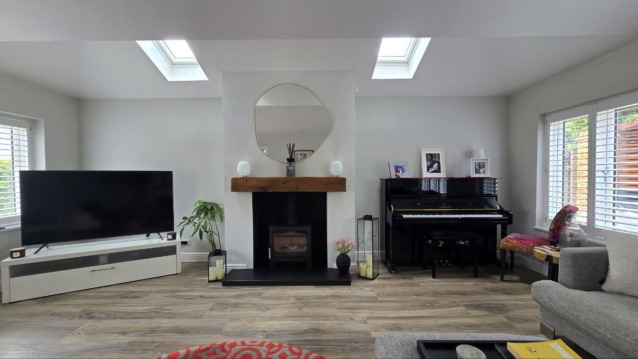 Sitting room with wood-burner, piano and concealed audio in a Surrey smart home
