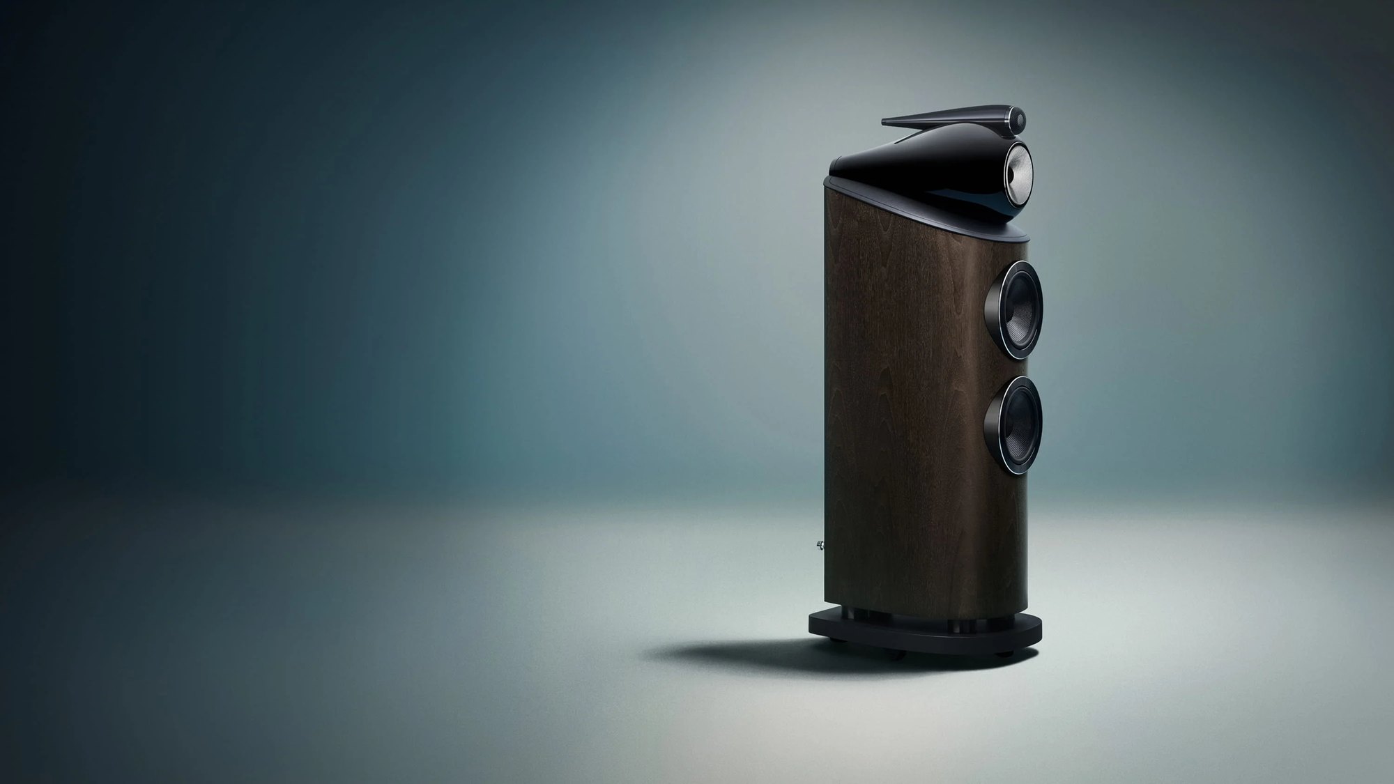 Bowers & Wilkins 803 D5 in a dark walnut finish on a darkened stage
