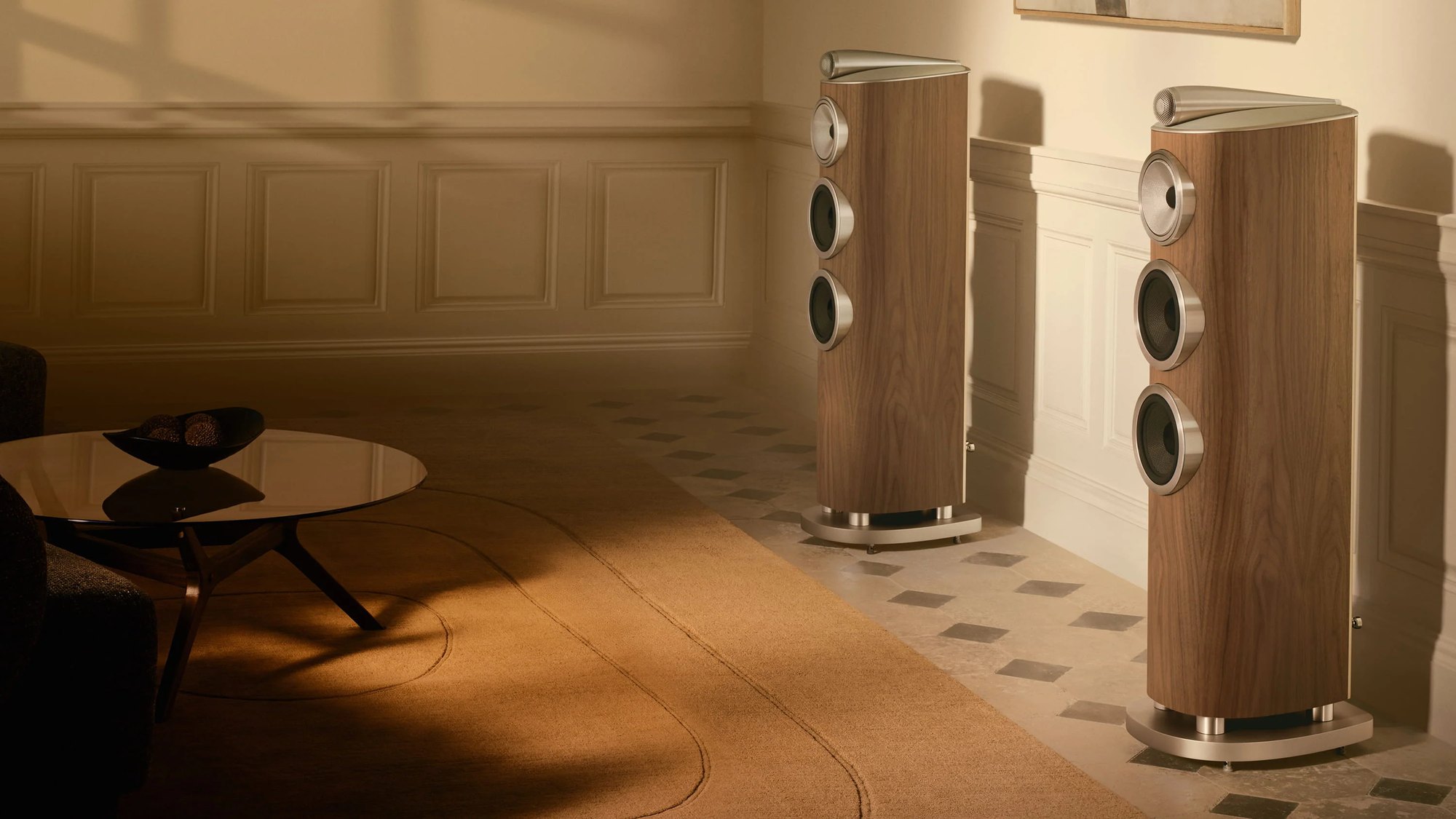 A pair of Bowers & Wilkins 804 D5 speakers in a light walnut finish in a sunlit room